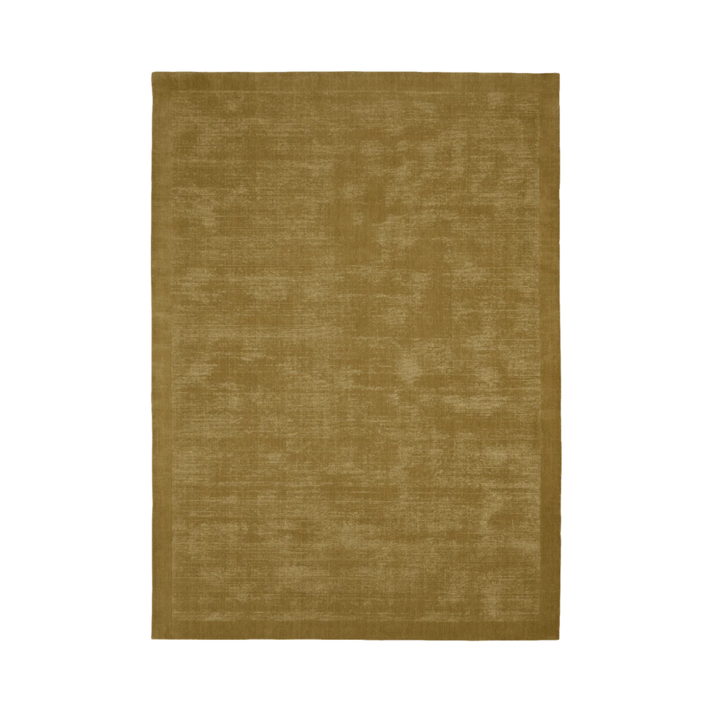 The Tait rug -  pistachio, by Tribe Home is handloomed in a golden green hue, with New Zealand wool for comfort and durability.