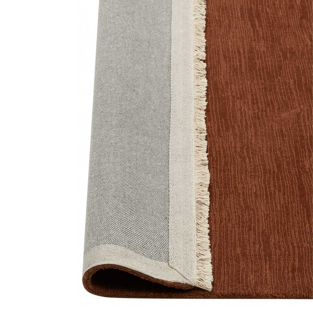 Contemporary Alessandre Rug in warm Clay colourway displayed in modern interior space