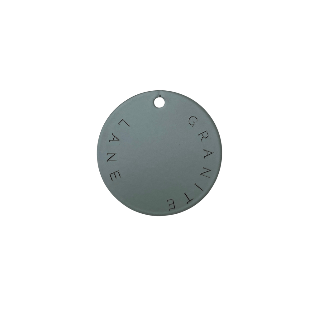 Round metallic sample swatch of the Granite Lane Bayleaf green Mirror Frame