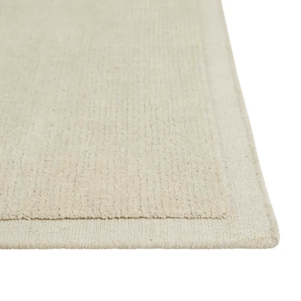 GlobeWest Bower Frame Rug – Cloud: light neutral shade featuring hand‑loomed wool and elegant border—perfect for tranquil minimalist spaces.