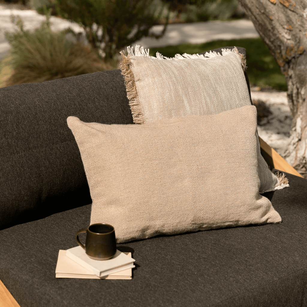 Baya Caspian Almond Cushion in soft almond hue on couch