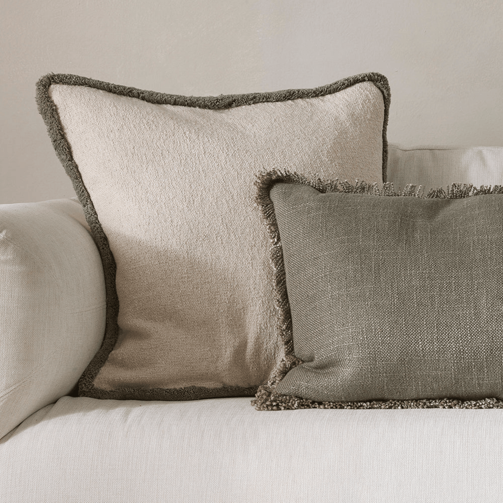 Baya Duke Sage Cushion in soft sage green on sofa