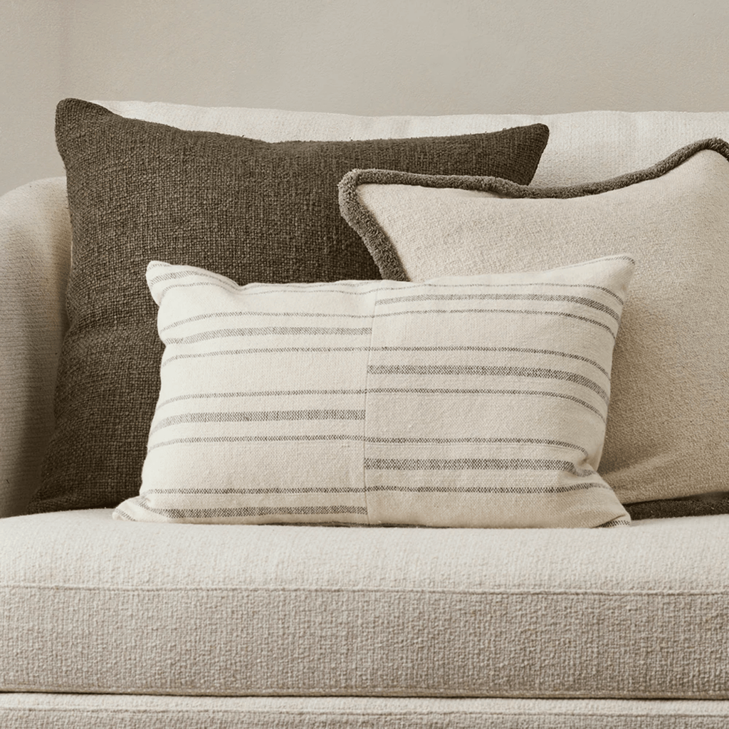 aya Duke Sage Cushion in soft sage green on sofa