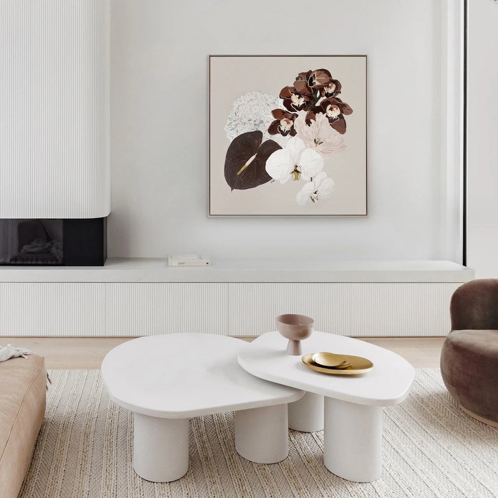 Modern living room with white coffee table, decorative items, and Dusk by Adele Naidoo framed canvas on the wall.