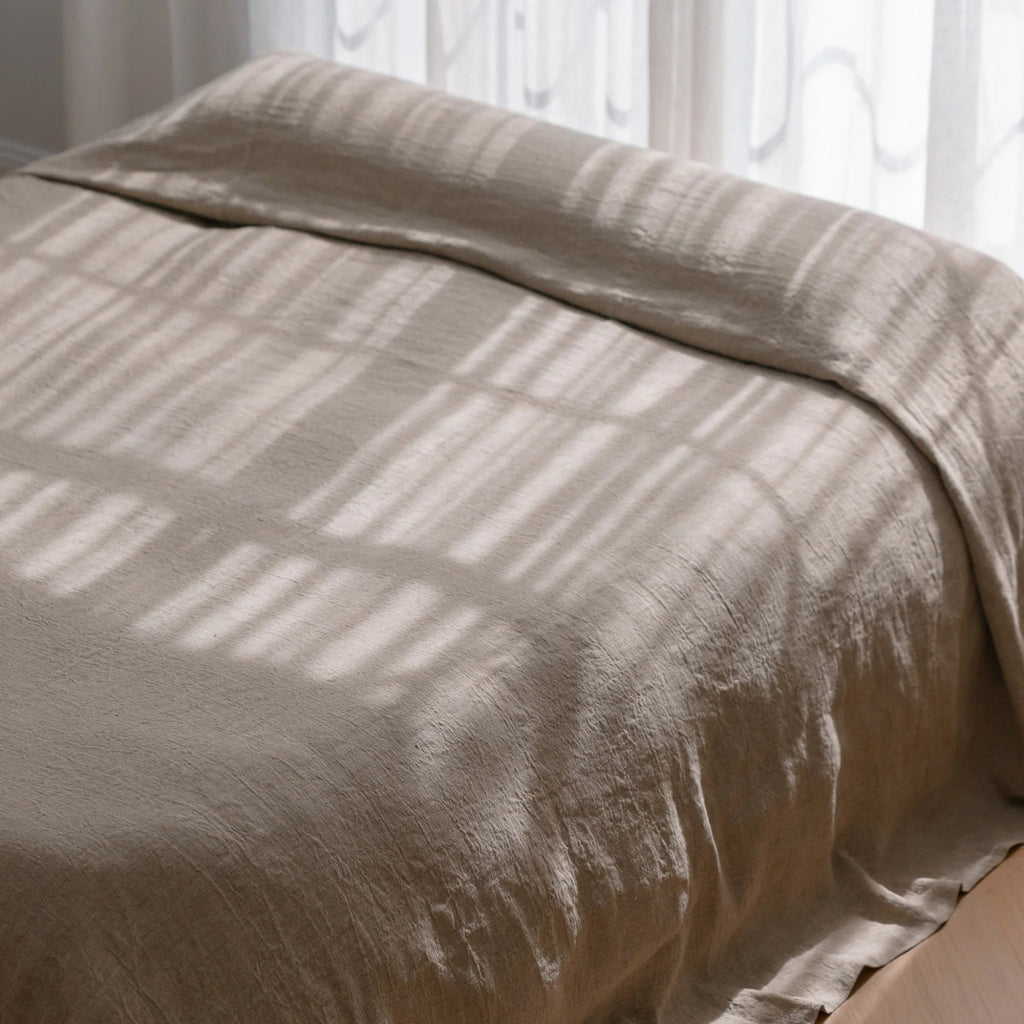 Natural linen bedcover by Eadie Lifestyle featuring soft, textured fabric in neutral tone.
