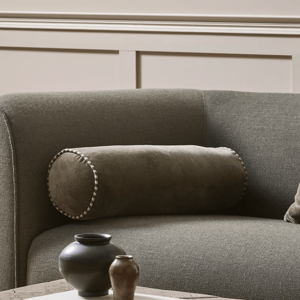 Baya Elliot Thyme Bolster Cushion in green tones on sofa