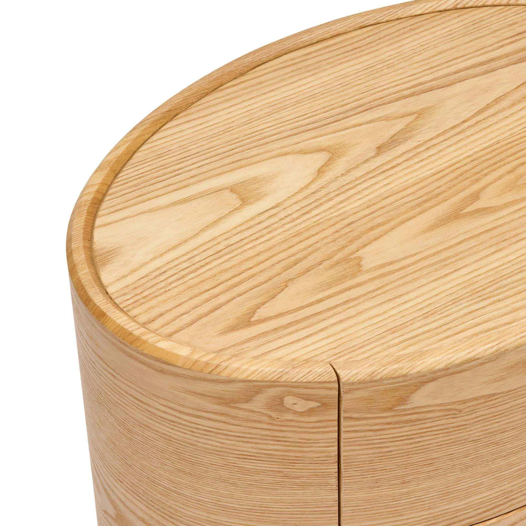 Finn Oval Bedside in natural ash — bedside table angled view showing smooth curved edges and drawer handles