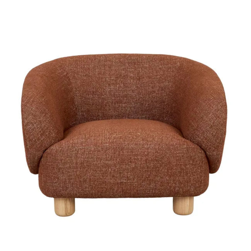 Flo Occasional Chair in brick fabric, front view displaying the chair's rounded silhouette and comfortable seating area with natural ash legs