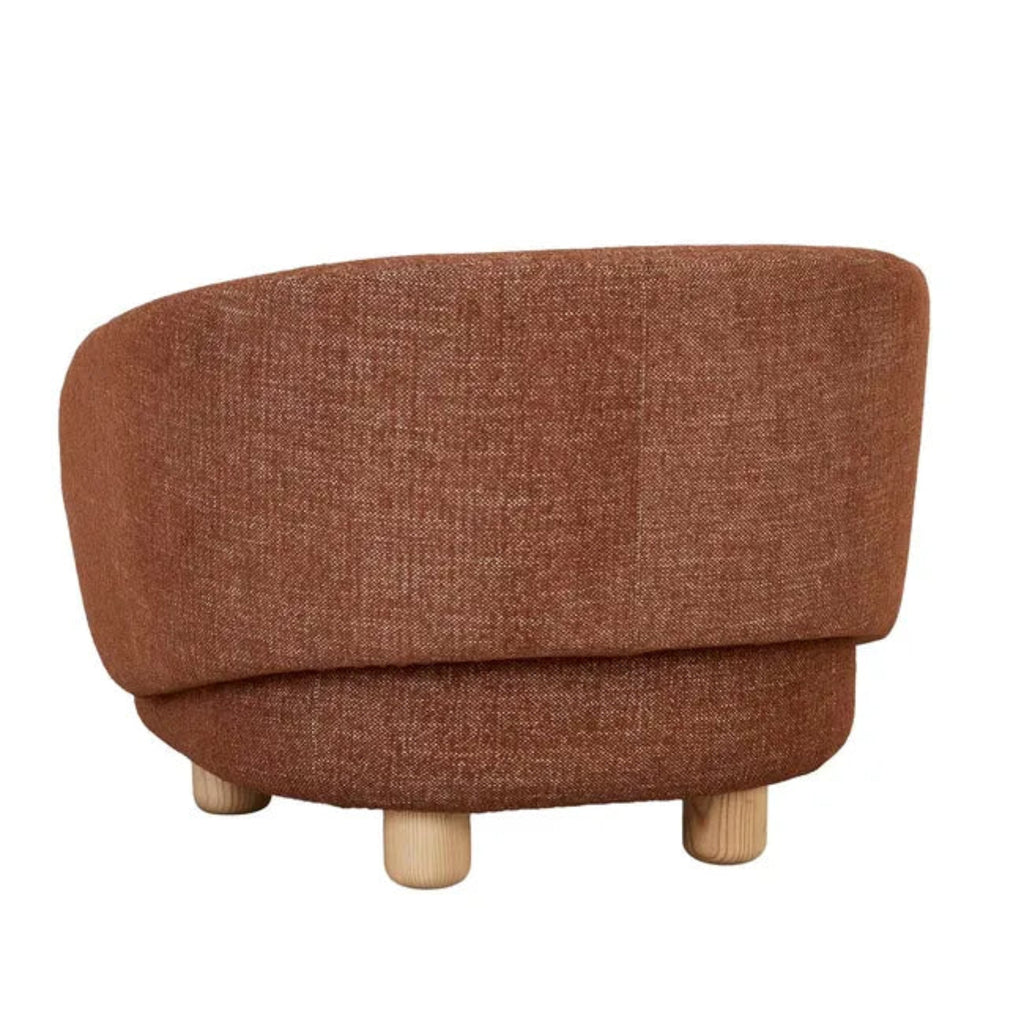 Back of the Flo Occasional Chair with textured fabric upholstery, curved barrel back design, and four natural ash wooden legs.