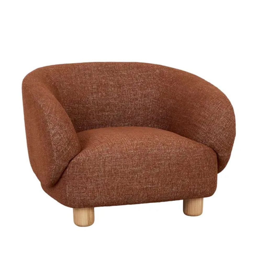 Flo Occasional Chair in brick fabric with natural ash wooden legs, front three-quarter view showing curved design and textured upholstery"