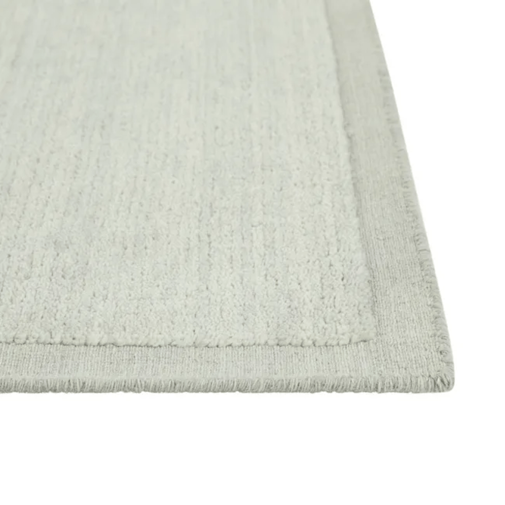 GlobeWest Bower Frame Rug – Seafoam: light blue‑green tone in luxurious hand‑woven wool, with elegant frame detailing for cool, breezy charm.