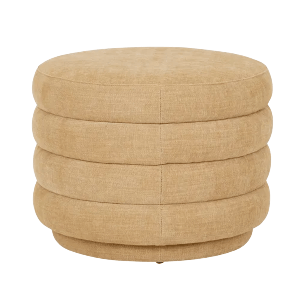 GlobeWest Kennedy Ribbed Medium Round Ottoman upholstered in Copeland Honey fabric, featuring soft curved edges and textured ribbed detailing