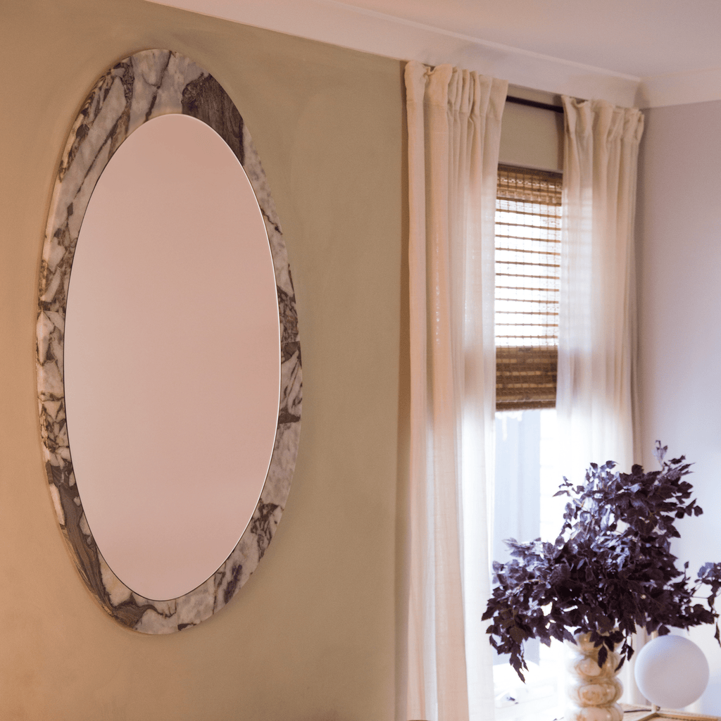 Granite Lane Ora Ocean Marble Mirror Organic in bedroom room setting with decor and natural light