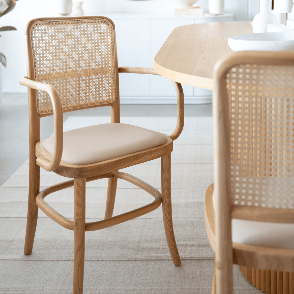 Nude tone Lacie Dining Chair with solid American ash legs and natural rattan woven back.