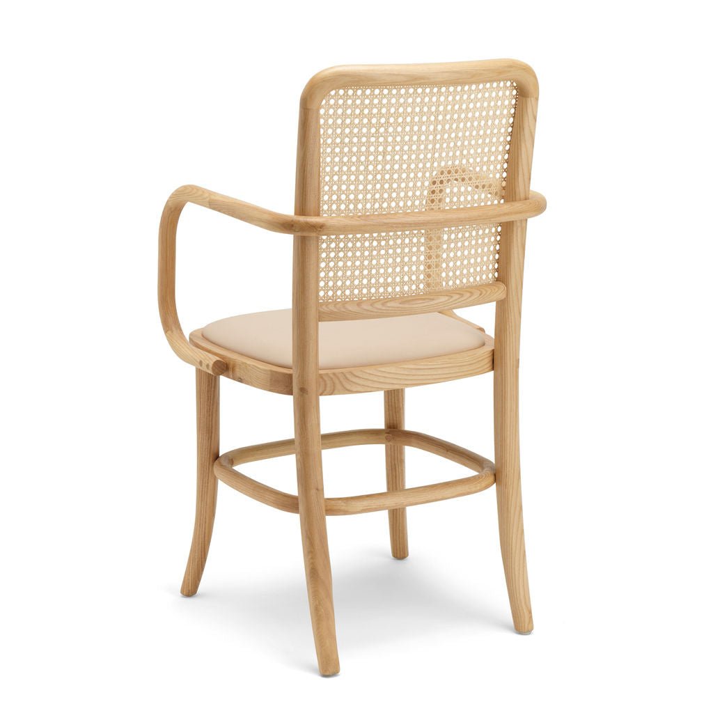Granite Lane’s exclusive Lacie Dining Chair — nude vegan leather seat, ash wood frame, woven cane back