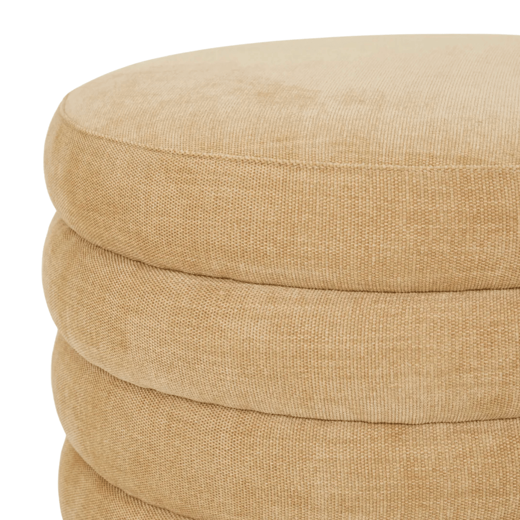 Beige ottoman with a textured surface on a white background