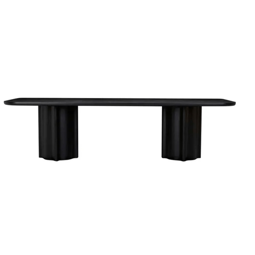 Sleek black timber dining table, its soft-edge rectangular surface resting atop bold, sculptural fluted pedestal legs.