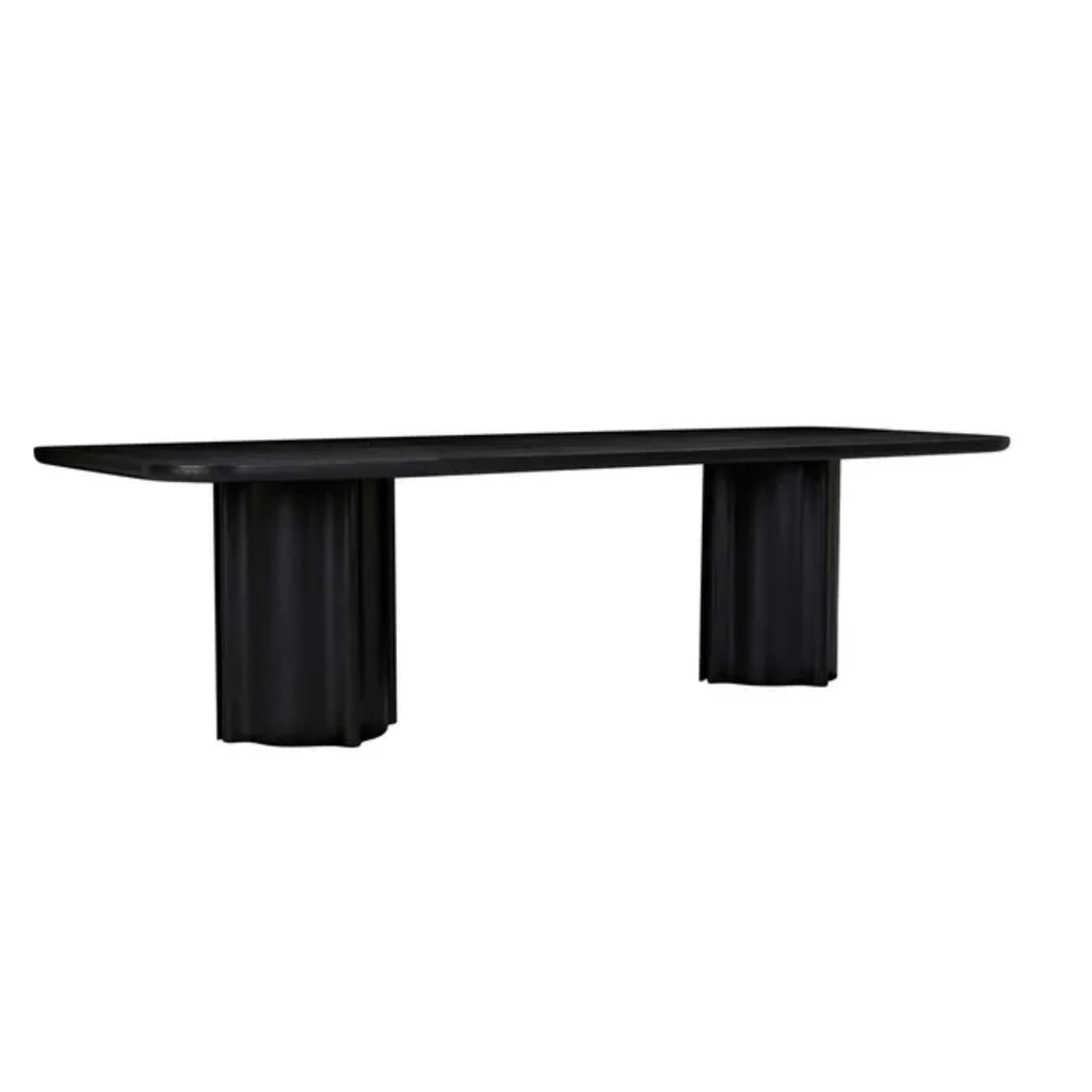Modern dining table with a smooth matte-black oak top, supported by chunky black oak column legs with pronounced vertical fluting.