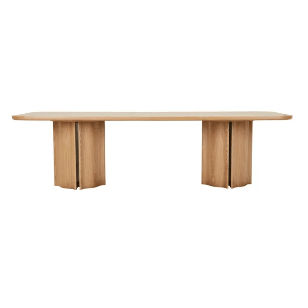 Leon Rectangular dining table in light ash veneer, with softly rounded edges and substantial fluted ash column legs beneath.
