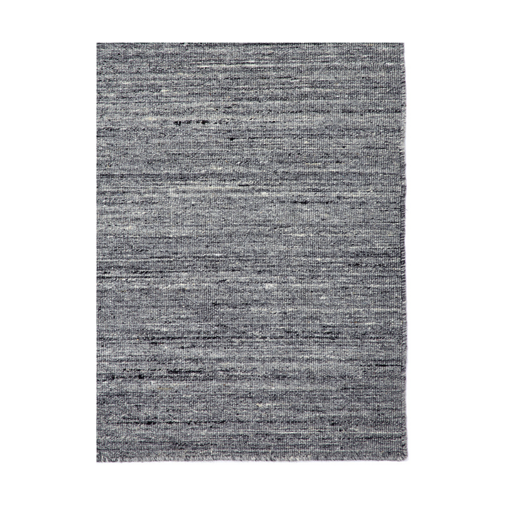 The Morrison rug from Tribe Home, adds a sense of neutrality and balance. Handmade with wool and cotton for longevity and durability. Featured in shades of  multi-coloured greys and hints of ivory.