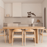 Modern oak dining table styled in open-plan living space with neutral tones – available now from Granite Lane