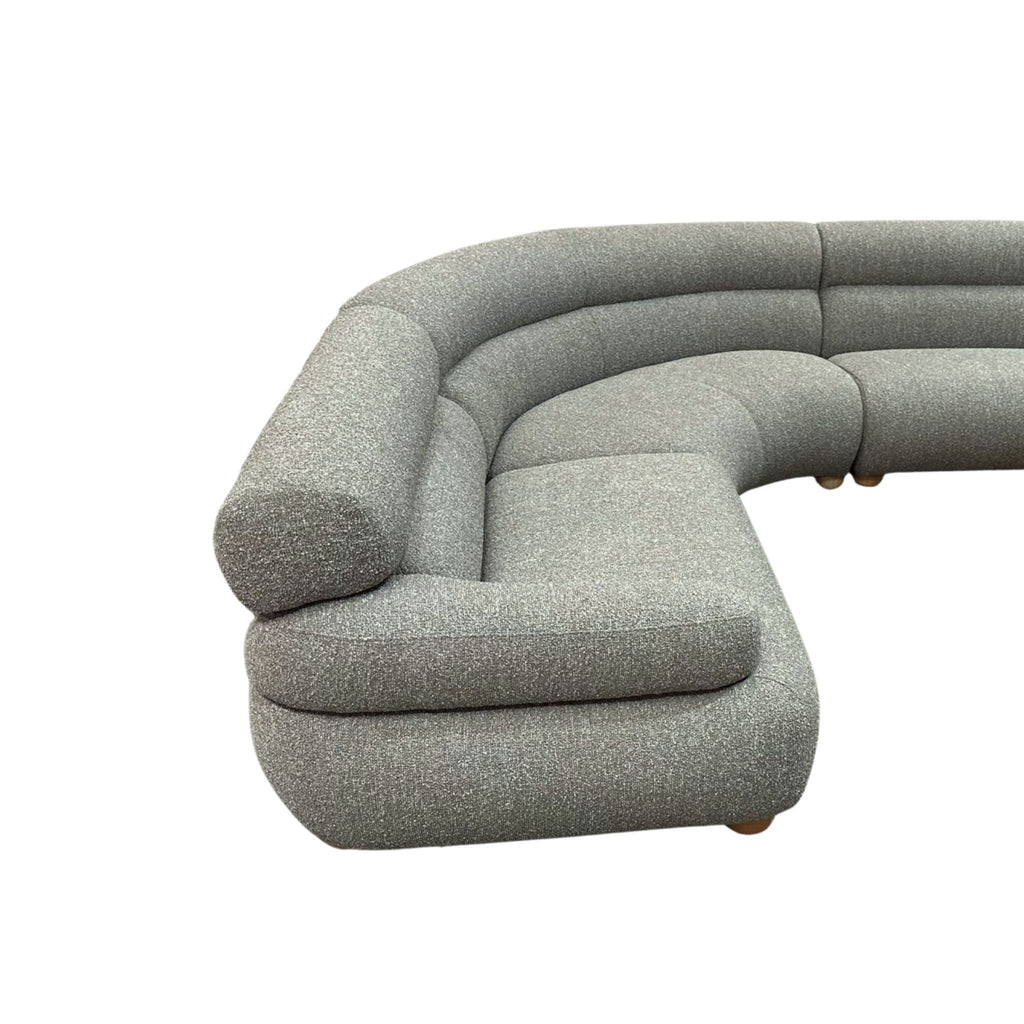 Gray textured curved modular sofa with back scrool on a white background