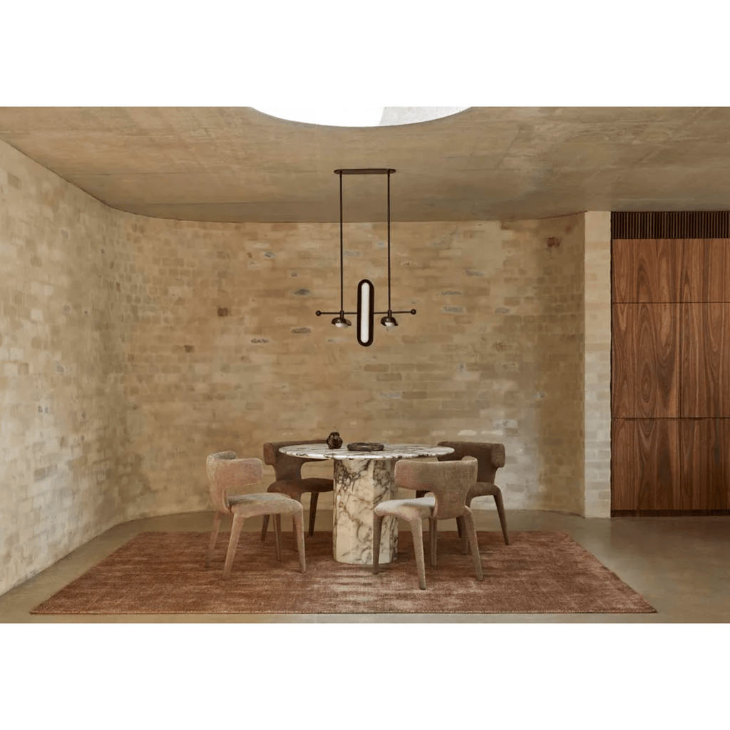 Living room showing Tepih Neptune Rug in Ginger with plush wool pile styled beside a sofa.