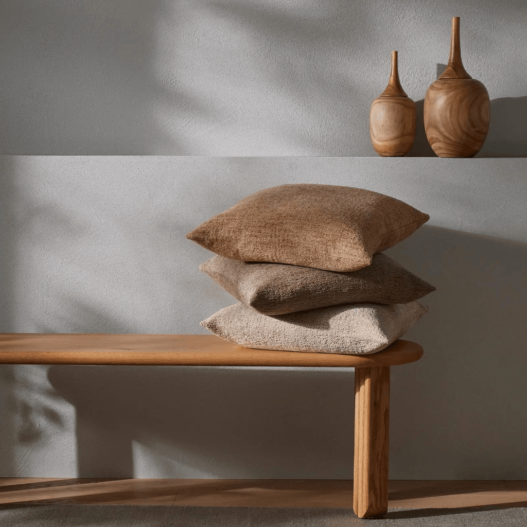 Stack of Laurent Cushions in Chai displaying plush feather-filled shape and versatile tone for layering
