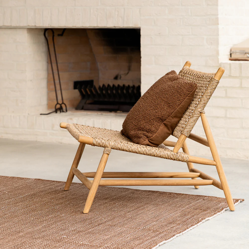 Piper Cushion Tobacco by Baya styled on outdoor chair adding warmth and relaxed sophistication