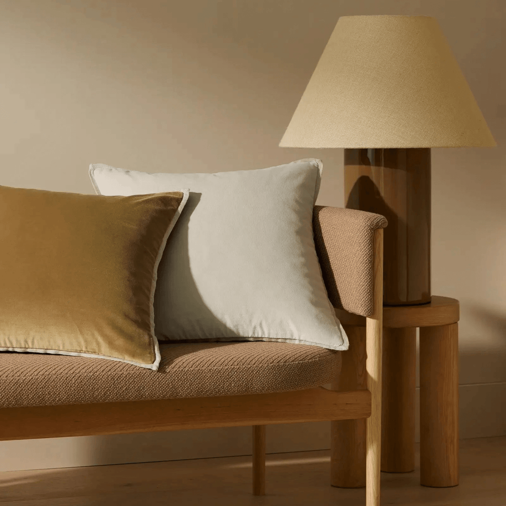 Francesca Olive velvet cushion styled on chair, highlighting rich texture and warm neutral tone in home interior.