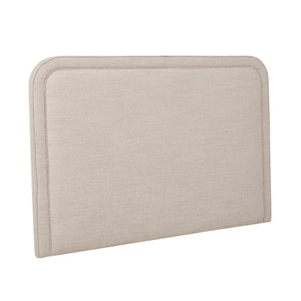 Angled view of GlobeWest Hugo Bedhead in Natural Speckle fabric, highlighting soft vertical panelling, structured form, and contemporary upholstered finish