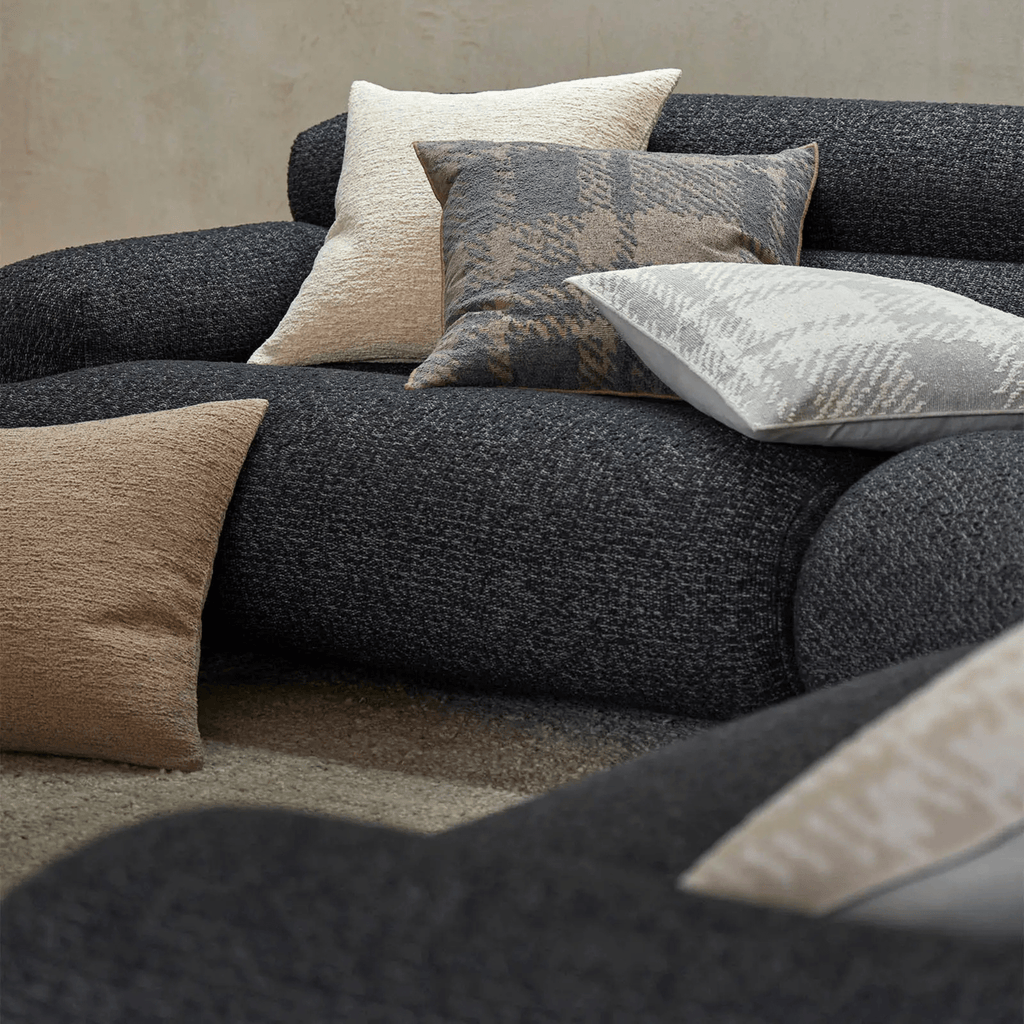 Lifestyle image of grey sofa and laurent cushion macadamia