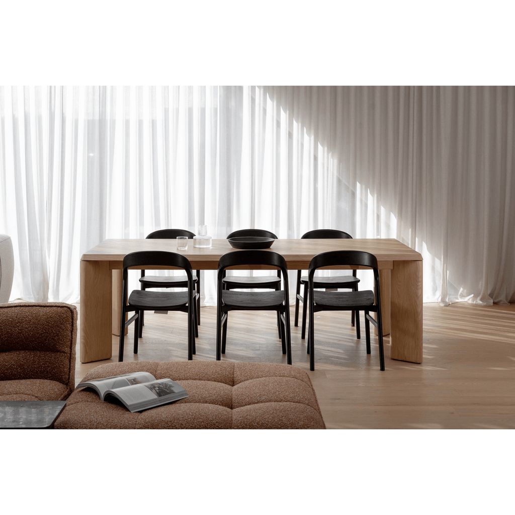 master pacific lifestyle shot of lenny dining table in oak creama with black dining chairs in modern home